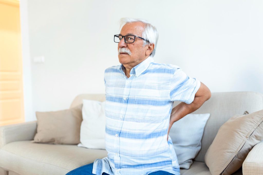 Elderly man with lower back and tailbone pain seeking physiotherapy treatment in Lucknow